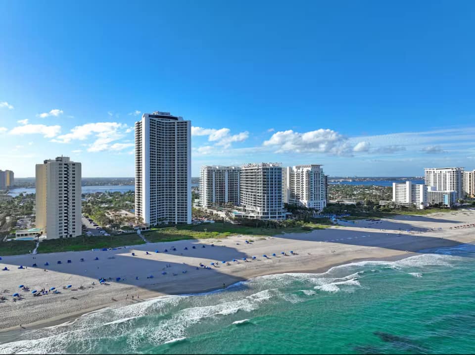 Aerial view of the two resort buildings on the Singer Island shoreline between ocean and Intracoastal