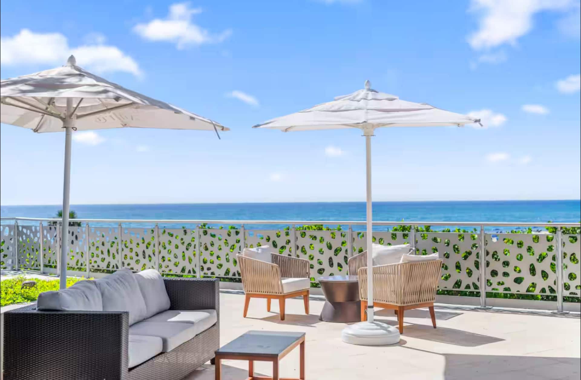 The spa's oceanfront terrace with umbrellas and lounge seating