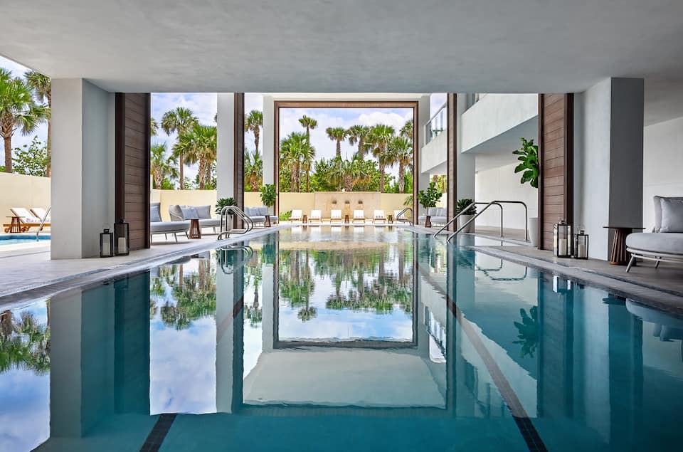 The indoor hydrotherapy lap pool with palm reflections in the glass