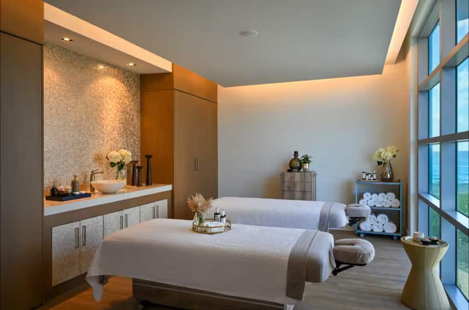 Twin massage tables prepared in a warm-toned spa treatment room