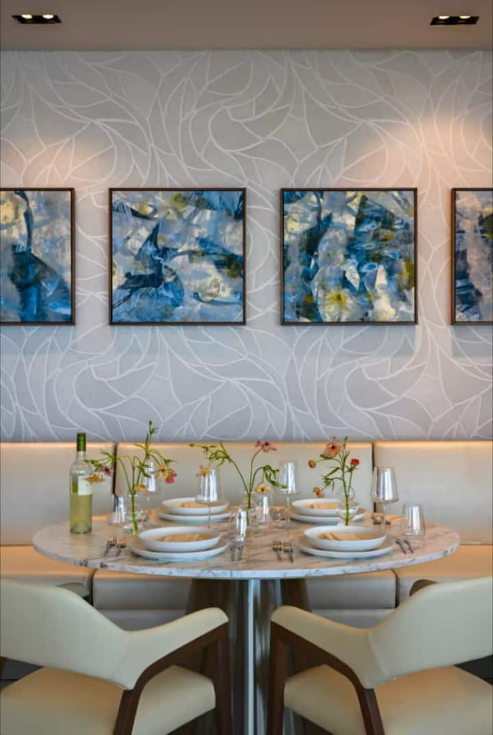 A spa treatment room with blue artwork and candlelight