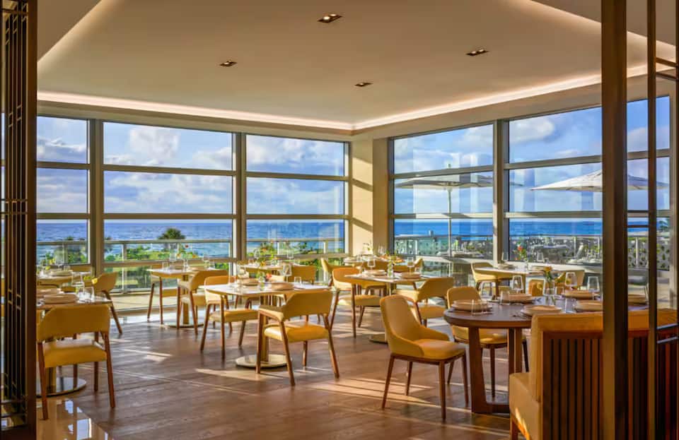 Restaurant dining room with ocean views through corner glass