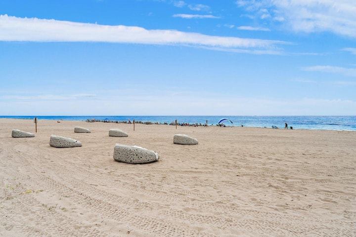 A wide stretch of Singer Island beach with loungers and umbrellas