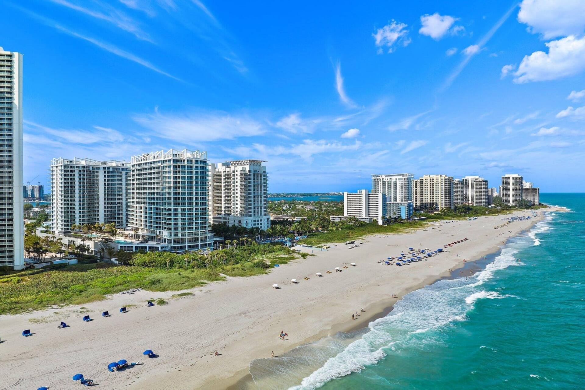 Aerial view of the Singer Island shoreline, with the resort buildings on a narrow strip between the Atlantic and the Intracoastal