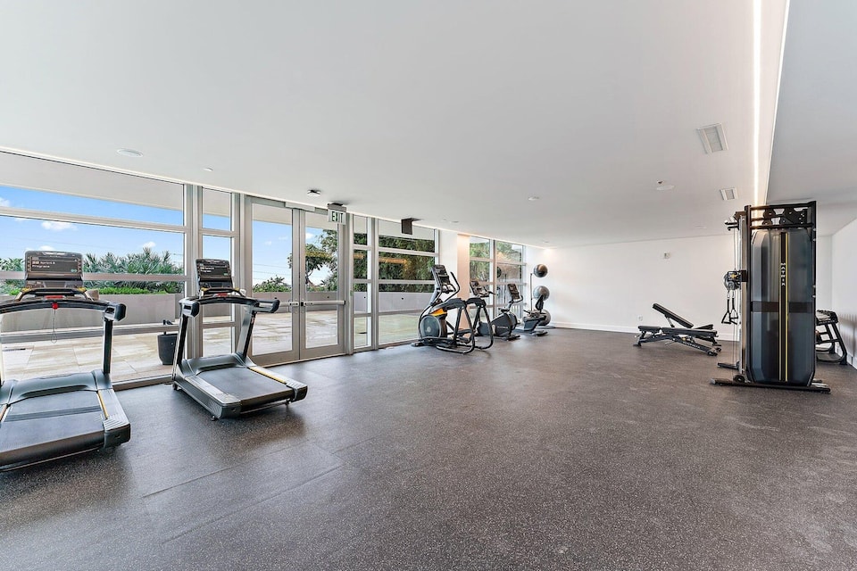 The resort fitness centre with treadmills and weights beside the windows