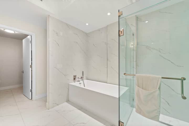 A spa-style bathroom with a soaking tub and glass shower