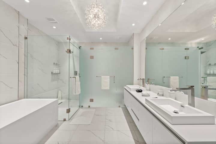 A marble bathroom with a walk-in rain shower