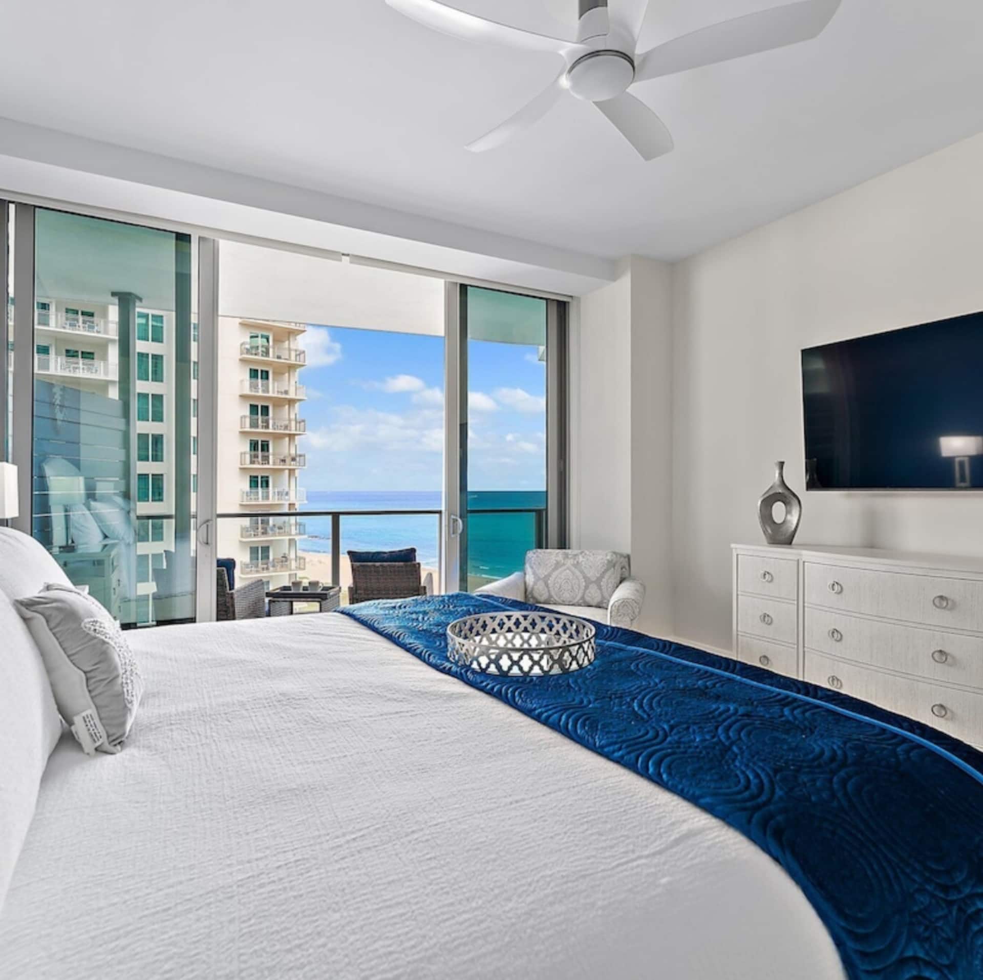 The king suite with the balcony and ocean beyond the glass