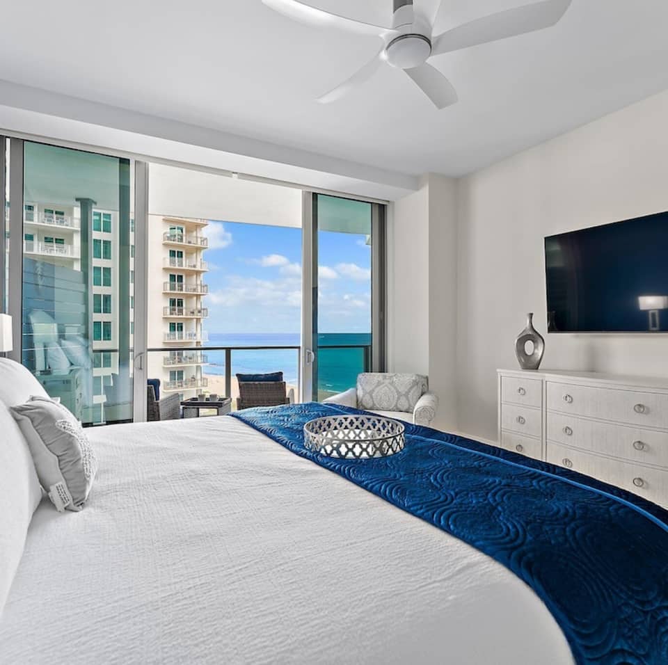 The king suite with the balcony and ocean beyond the glass