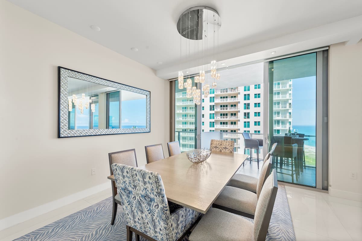 The dining table set beside the ocean-view windows