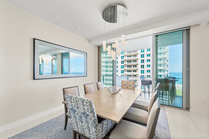 The dining table set beside the ocean-view windows