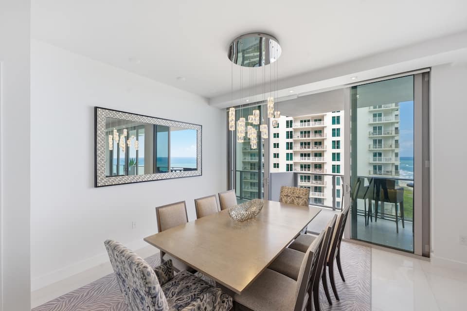 The dining room with the ocean through floor-to-ceiling glass