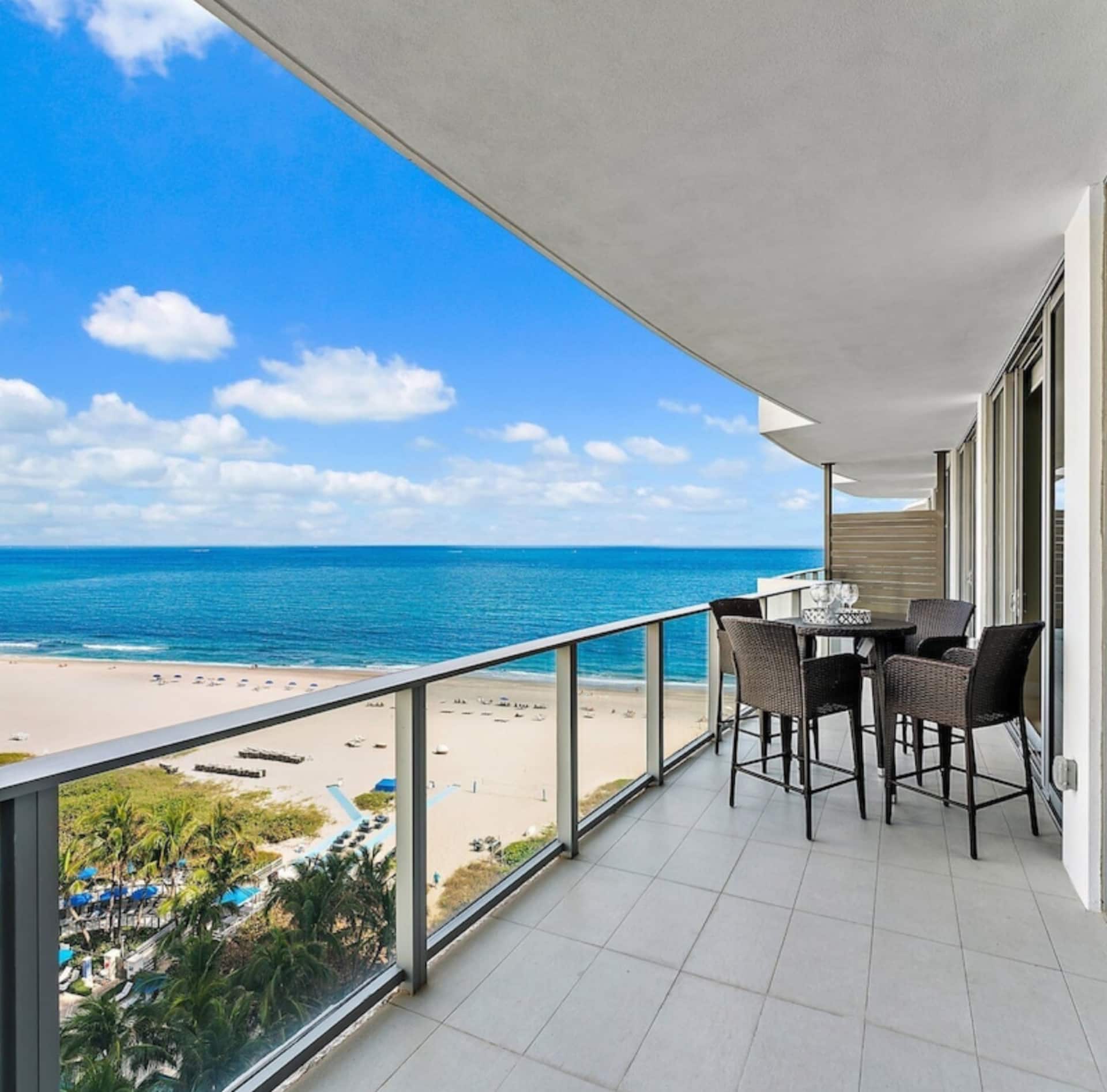 The residence balcony overlooking the beach and turquoise water