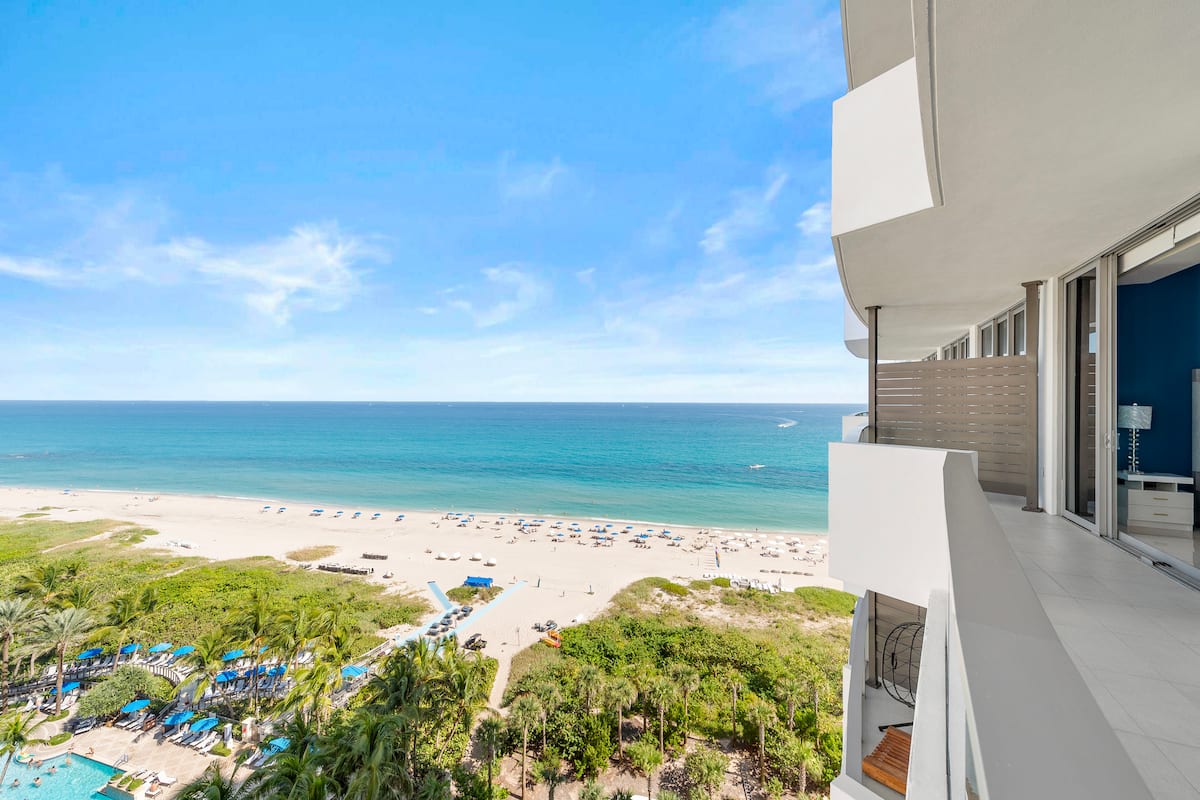 Looking down the coast from the balcony, over the resort pools and palms